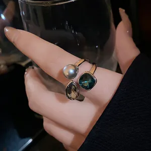 Elegant vintage gold-plated open ring featuring pearl and emerald-cut green gemstone
