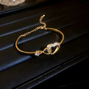 Detailed view of the interlocking heart hollow bracelet with sparkling zircon stones