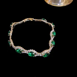 Elegant gold finish bracelet with oval green zircons and clear crystals