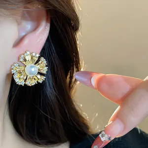 Detailed view of an elegant 18k gold plated flower ear clip featuring pearl and zircons