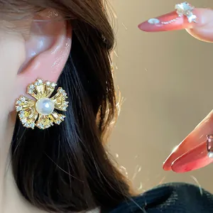 Close-up of elegant flower ear clip with sparkling zircon and central pearl detail.