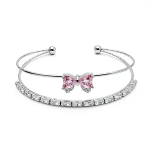 Elegant double-layered silver bangle featuring a pink crystal bow and baguette-cut zircons
