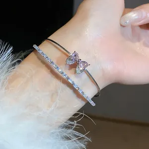 Detail view of a sparkling zircon bracelet featuring a charming pink heart bow design.