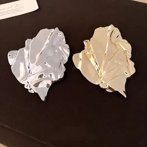Elegant gold and silver irregular pleated metal leaf brooches with premium mirror finish.