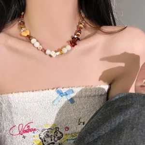 Detail view of Y2K style colorful beaded necklace featuring heart and puppy figure charms