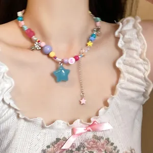 Detailed view of a colorful dopamine style beaded necklace with star charms on model