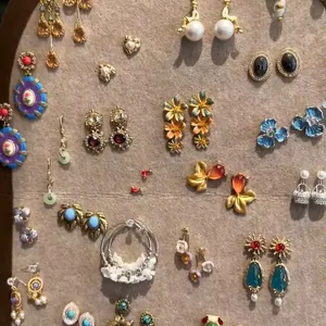 Collection of vintage-inspired floral and pearl earrings on a display board
