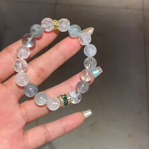 Close-up of translucent crystal beaded bracelet with emerald green and gold spacer