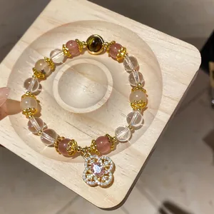 Beaded bracelet with tiger eye and hollow flower pendant, retro Maillard style jewelry