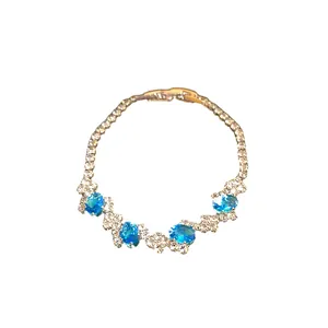 Sophisticated irregular silver-tone bracelet with sparkling blue oval stones and clasp.