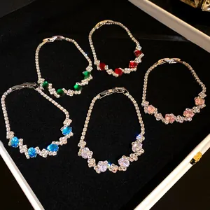 Detailed view of five elegant zirconia bracelets with colorful oval gemstone accents.