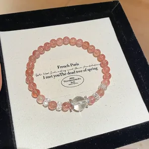 Close-up of strawberry quartz beaded bracelet with hollow flower caps in a jewelry box