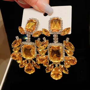 Close-up of vintage amber rhinestone drop earrings with rectangular and teardrop stones