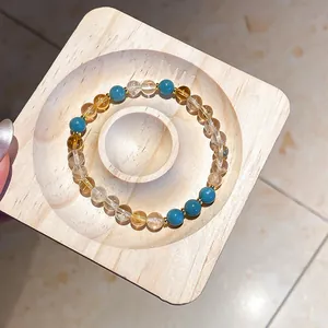 Detail view of a vintage Maillard style beaded bracelet with yellow and blue gemstones.
