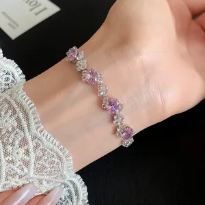 Detailed view of an elegant pink oval zircon bracelet with silver finish on a wrist