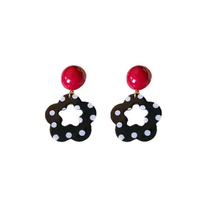 Retro black and white polka dot flower earrings with red studs for women.