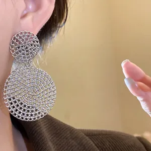 Elegant silver needle earrings featuring a hollow circular mesh drop design for women