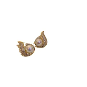 Elegant gold-tone fishtail stud earrings with sparkling rhinestones and white pearls