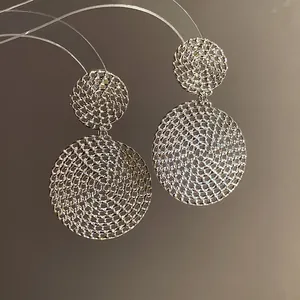Close-up view of elegant silver woven mesh hollow round drop earrings for a sophisticated look