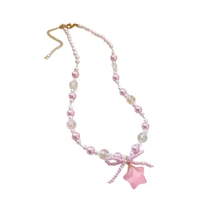 Elegant pink and white pearl necklace featuring a beaded bow and resin star pendant