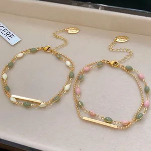 Detailed view of French vintage double-layer bracelets with green and pink beads