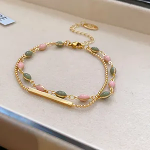 Detailed macro shot of a French vintage double-layer gold plated bracelet with enamel beads