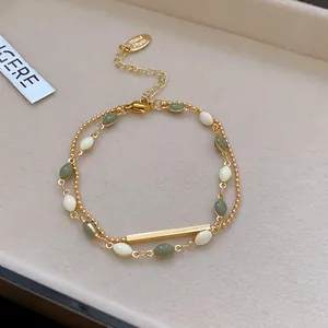 Detailed view of a French retro double-layer bracelet with green and white beads