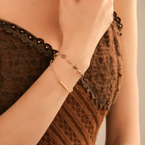 Close-up view of a French vintage double-layer gold plated bracelet worn on a woman wrist