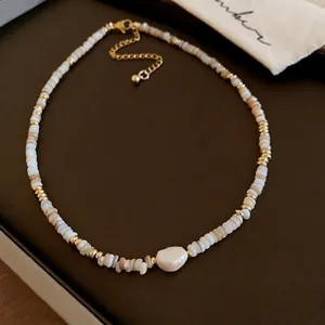 Elegant gold-plated pearl necklace featuring shell beads and central baroque pearl