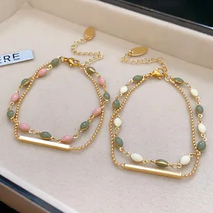 Elegant double-layered gold-plated bracelets featuring green and pink vintage style beads