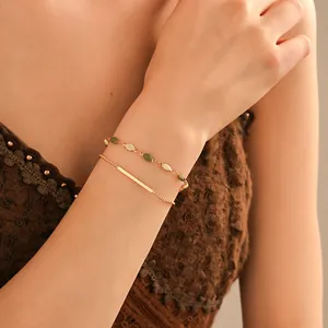 Detailed close-up of elegant gold plated double-layer bracelet on woman's wrist