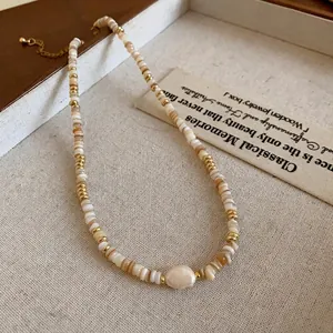 Elegant gold-plated necklace with natural pearls and shell beads in a wooden box