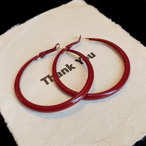 Sophisticated large dark red enamel hoop earrings with a retro glossy finish and silver pins