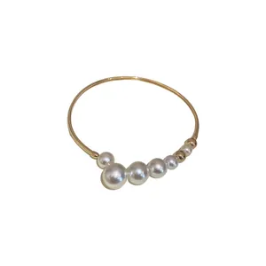 Elegant gold choker necklace with a gradient of white Baroque pearls on a white background.
