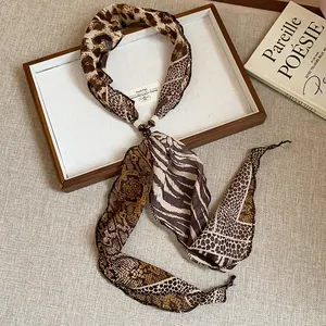 Detailed view of leopard and python print scarf necklace with elegant bead accent