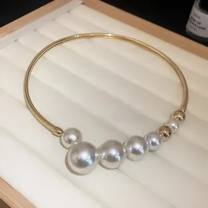 Detailed view of a French Baroque pearl choker necklace on a white jewelry display tray