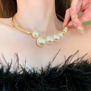 Close-up detail of a French baroque pearl choker necklace with a golden metal band