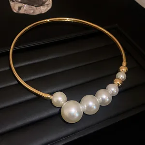 Close-up of elegant French Baroque pearl choker with gold geometric band detail