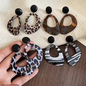 Vintage leopard print oversized acrylic earrings in brown and grey tortoiseshell styles.