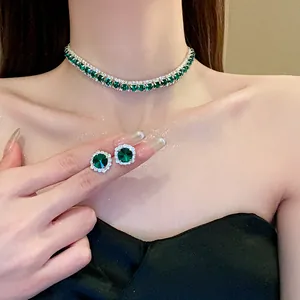 Close-up of elegant emerald green rhinestone necklace and matching stud earrings set