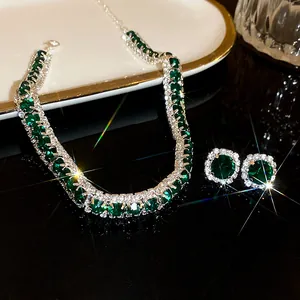 Close-up of elegant emerald green rhinestone necklace and earring set
