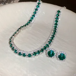 Close-up of elegant emerald green square cut rhinestone necklace and earrings set