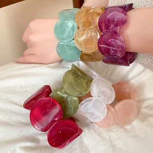 Detailed view of marbled acrylic link bracelets in vibrant colors with unique ink textures