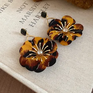 Detail of vintage Maillard leopard flower earrings with sparkling crystal centers.