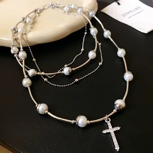 Elegant multi-layer pearl necklace featuring a sparkling rhinestone cross pendant for women