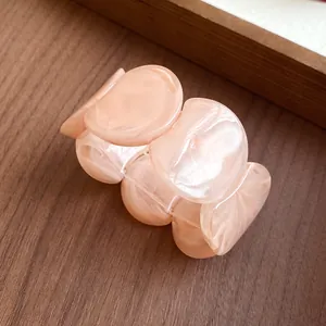 Detailed close-up view of a pink marbled acrylic chunky chain bracelet for women.