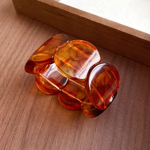 Macro view of vintage amber acrylic segment bracelet with smooth tortoiseshell texture