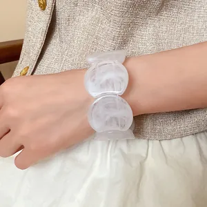 Close-up of a white marbled acrylic round spliced bracelet in Korean minimalist style.