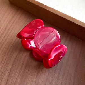 Detailed view showing the vibrant texture of a red marbled acrylic circular link bracelet