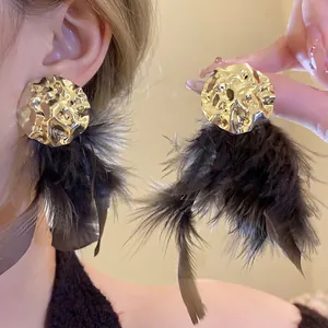Elegant gold hammered round earrings featuring dramatic dark brown feather tassels